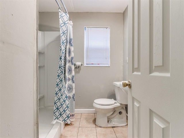 bathroom featuring tile patterned floors, a shower with curtain, and toilet