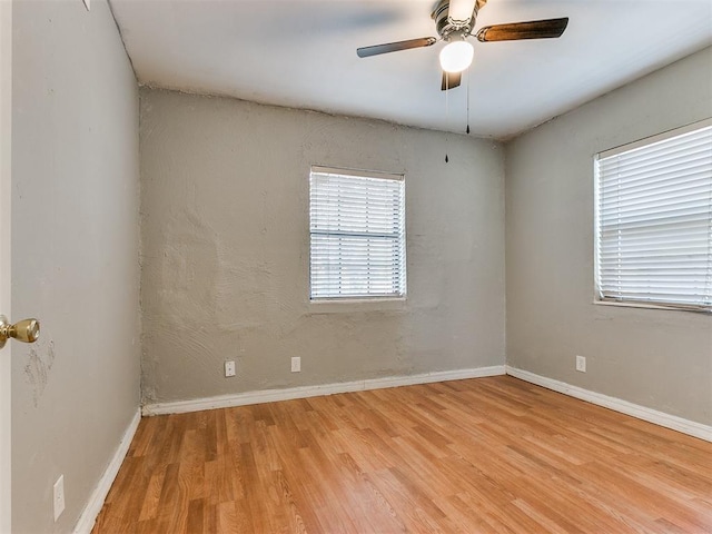 spare room with ceiling fan and light hardwood / wood-style floors