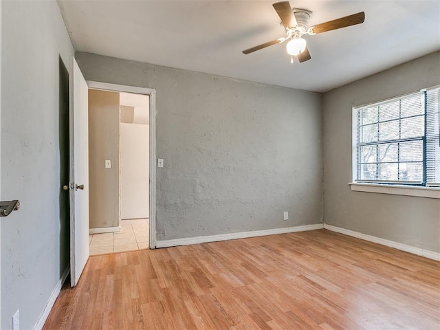 unfurnished room featuring ceiling fan and light hardwood / wood-style floors