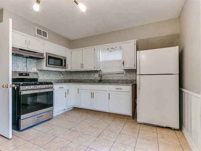 kitchen with white cabinetry, sink, decorative backsplash, light tile patterned floors, and appliances with stainless steel finishes