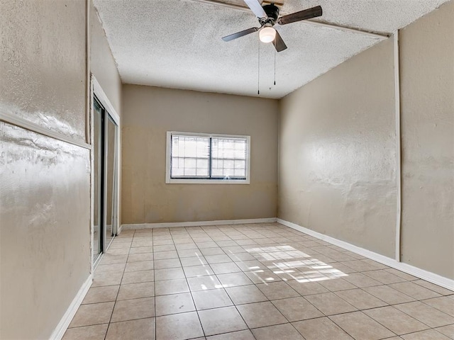 unfurnished bedroom featuring a textured ceiling, ceiling fan, and light tile patterned flooring