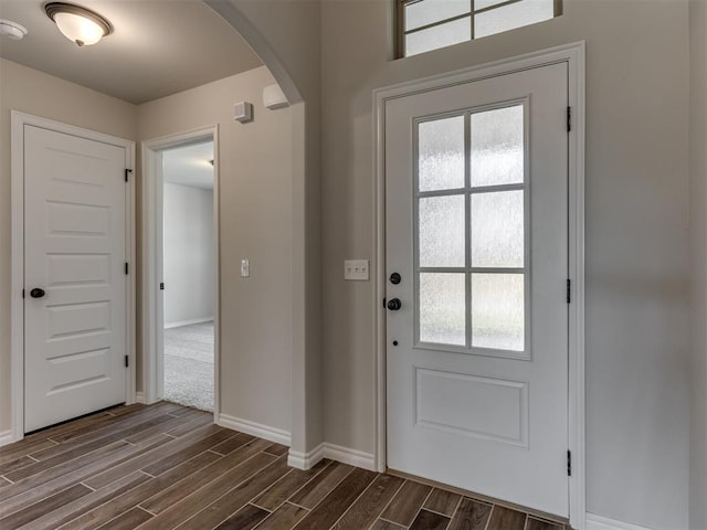 entrance foyer with dark hardwood / wood-style flooring and a wealth of natural light