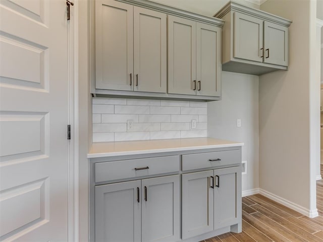 kitchen with tasteful backsplash and light hardwood / wood-style floors