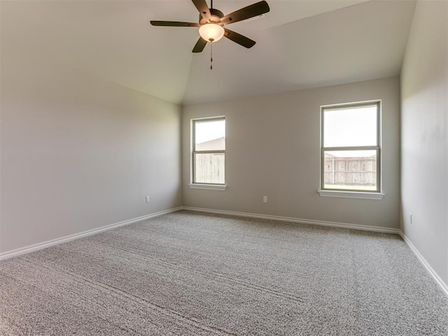 empty room featuring light colored carpet, vaulted ceiling, and ceiling fan