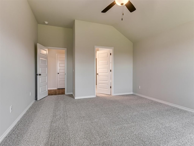 unfurnished bedroom with carpet, ceiling fan, and vaulted ceiling