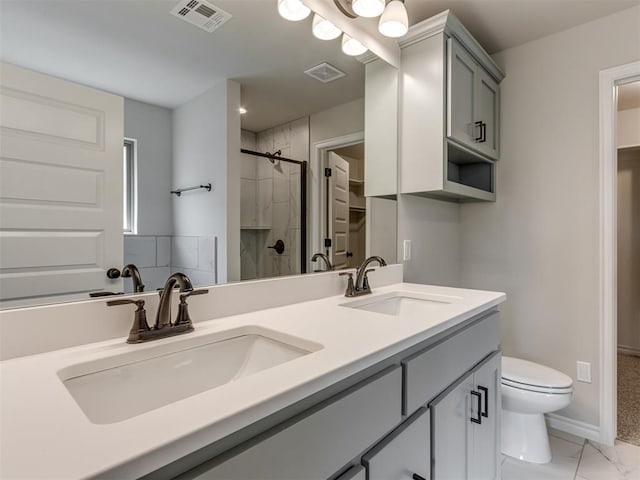 bathroom with toilet, vanity, and walk in shower