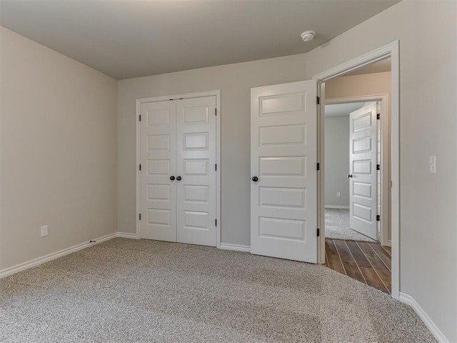 unfurnished bedroom with hardwood / wood-style floors and a closet