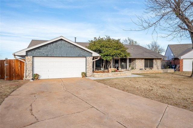 single story home featuring a garage and a front yard