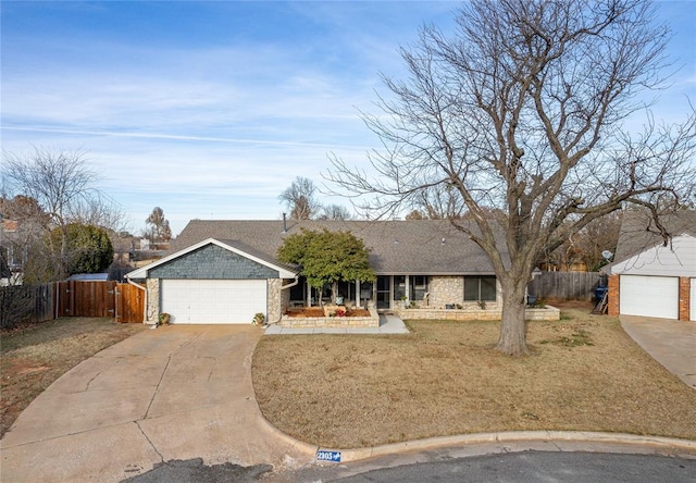 ranch-style home with a garage and a front lawn