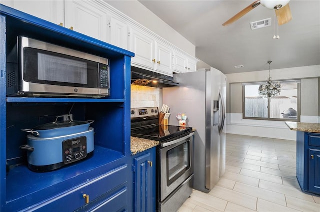 kitchen featuring ceiling fan with notable chandelier, decorative backsplash, blue cabinetry, white cabinetry, and stainless steel appliances