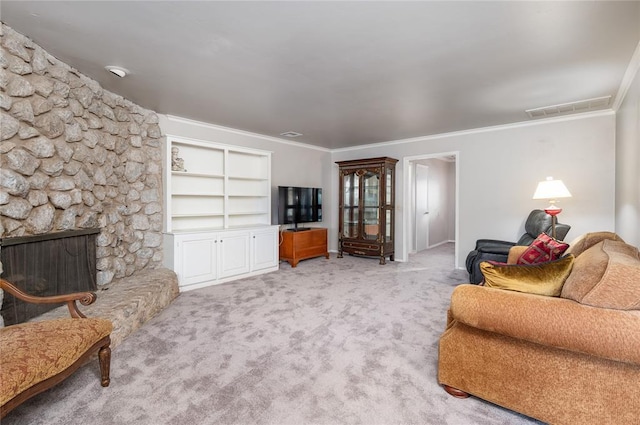 carpeted living room with built in features, a stone fireplace, and ornamental molding