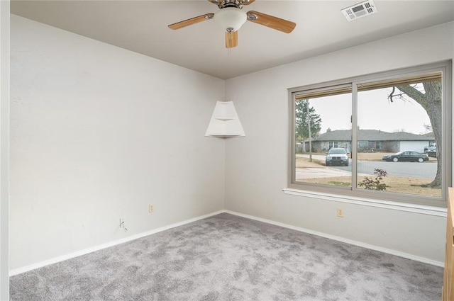 carpeted spare room featuring ceiling fan