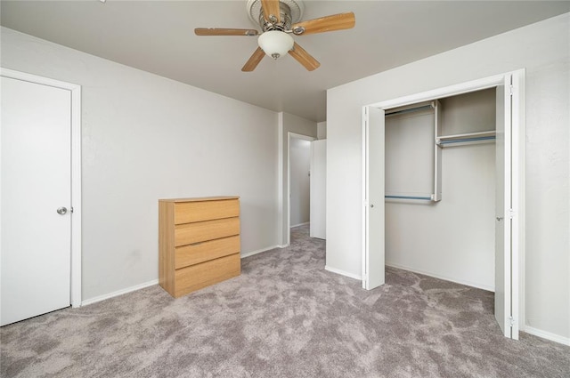 unfurnished bedroom featuring ceiling fan, a closet, and light colored carpet