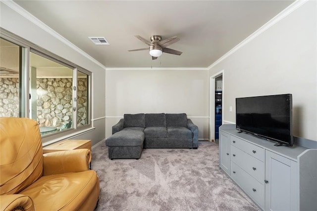 living room with light colored carpet, ceiling fan, and ornamental molding