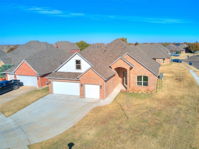 view of front of property featuring a front lawn and a garage