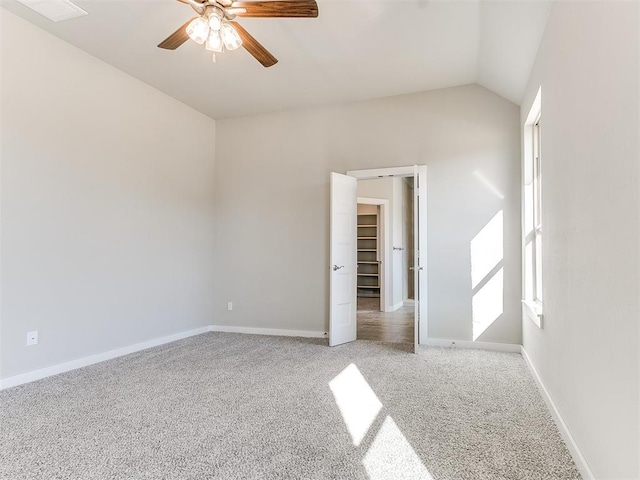 unfurnished bedroom with carpet, vaulted ceiling, and ceiling fan