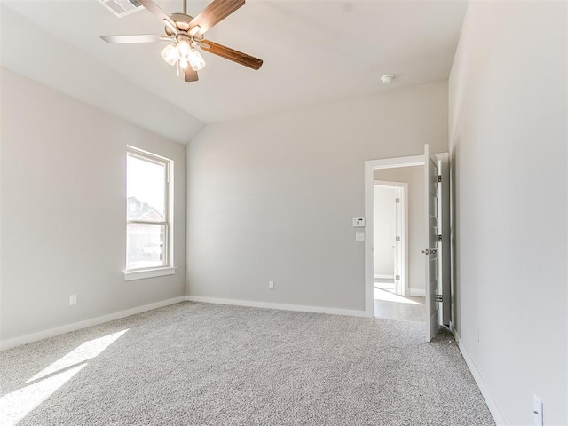 spare room featuring carpet flooring, ceiling fan, and lofted ceiling