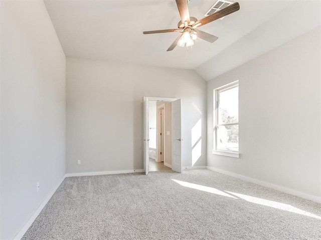 unfurnished room with ceiling fan, light colored carpet, and vaulted ceiling