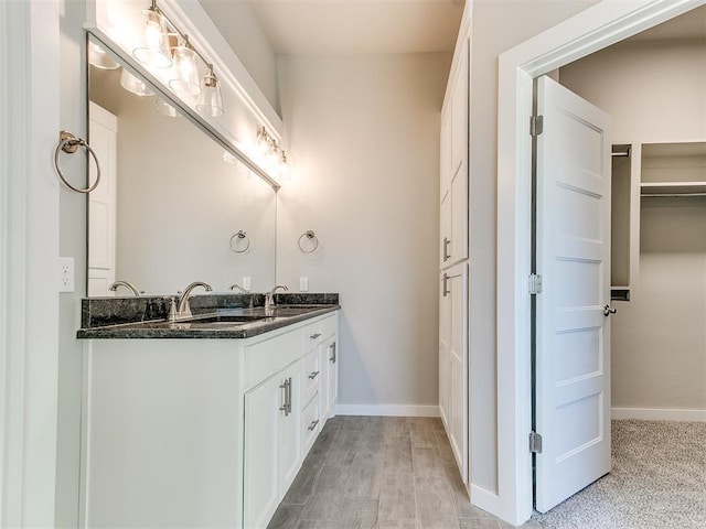 bathroom with hardwood / wood-style floors and vanity