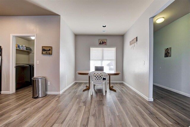 dining space featuring wood finished floors and baseboards