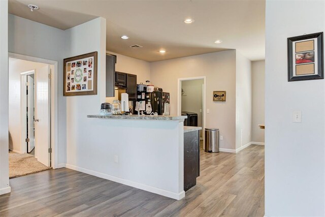 kitchen with light wood finished floors, light countertops, and recessed lighting