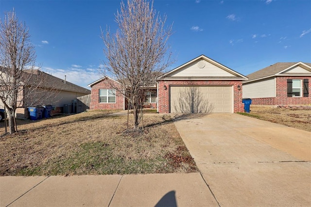 ranch-style home with a garage, concrete driveway, brick siding, and central AC