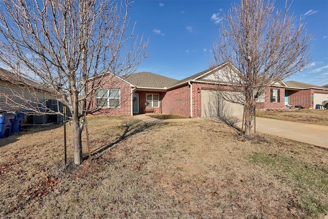 ranch-style home featuring a garage, driveway, brick siding, and a front yard