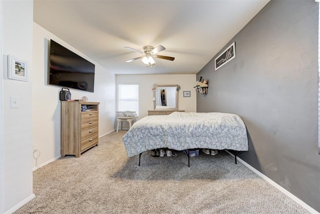 bedroom with ceiling fan, baseboards, and carpet flooring