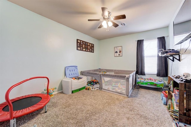 game room with a ceiling fan, visible vents, and carpet floors