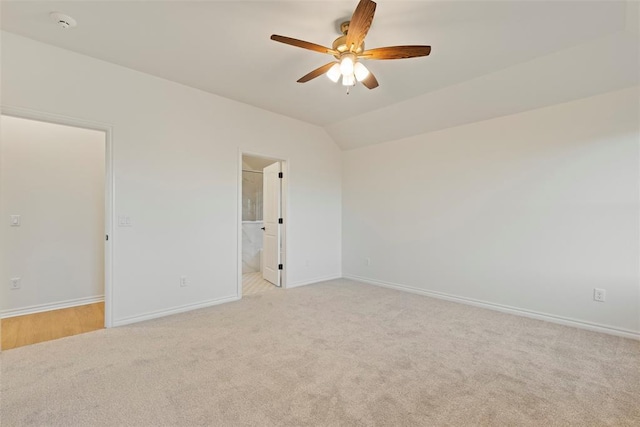 carpeted spare room featuring ceiling fan and lofted ceiling