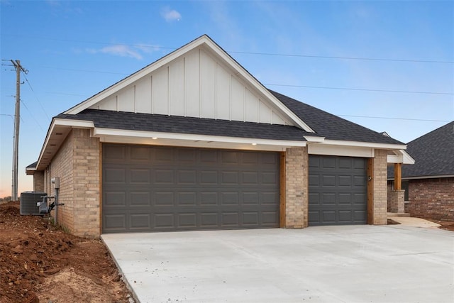 property exterior at dusk featuring central AC and a garage