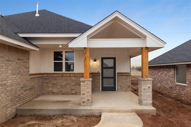 view of exterior entry with covered porch