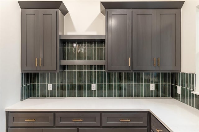 kitchen with gray cabinetry and decorative backsplash