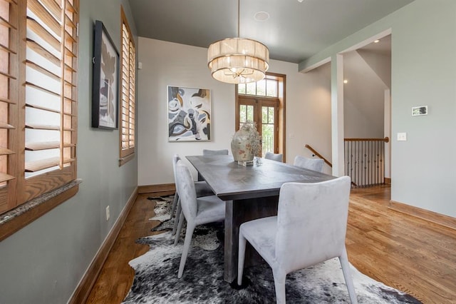 dining room featuring french doors, a notable chandelier, and hardwood / wood-style flooring