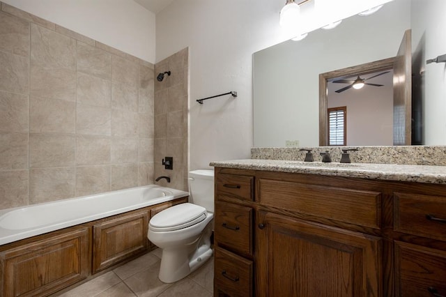 full bathroom featuring ceiling fan, tiled shower / bath combo, tile patterned floors, toilet, and vanity