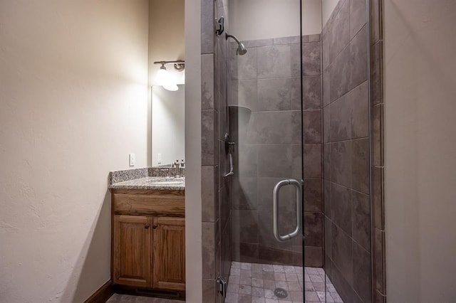 bathroom featuring vanity and a shower with shower door