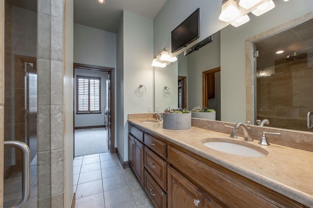 bathroom with tile patterned flooring, vanity, and walk in shower