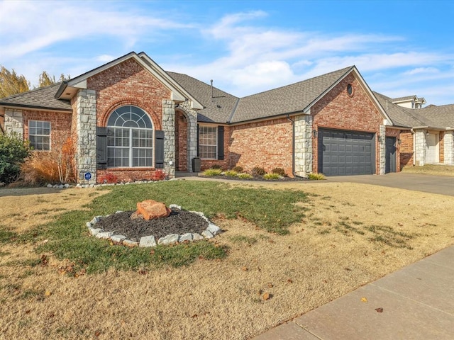 view of front of property with a garage and a front lawn