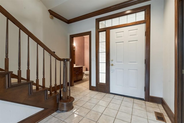 tiled entryway with ornamental molding