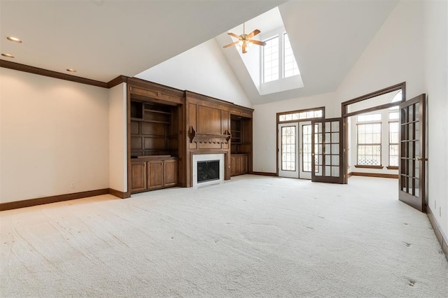 unfurnished living room featuring light carpet, high vaulted ceiling, ceiling fan, and crown molding