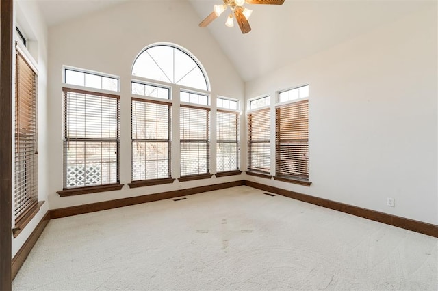 unfurnished sunroom with plenty of natural light, ceiling fan, and lofted ceiling