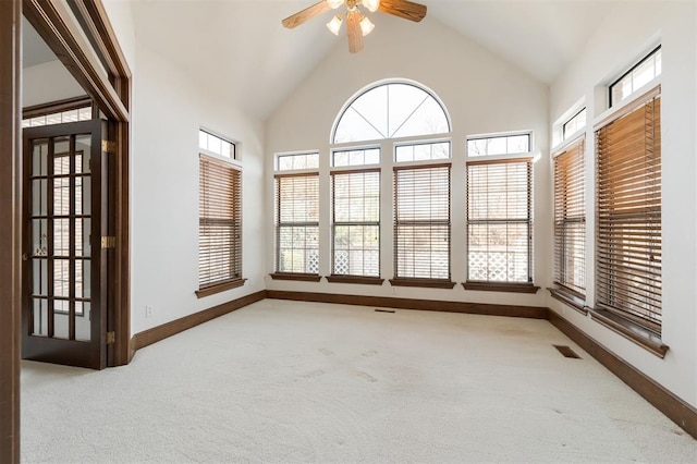 unfurnished sunroom with vaulted ceiling and ceiling fan