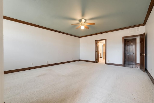 carpeted spare room featuring ceiling fan and ornamental molding