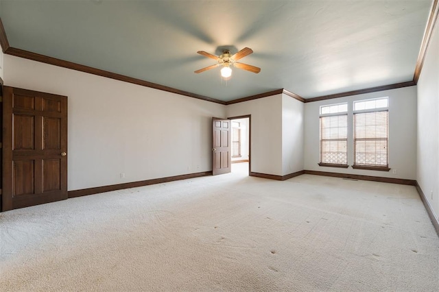 carpeted empty room featuring crown molding and ceiling fan