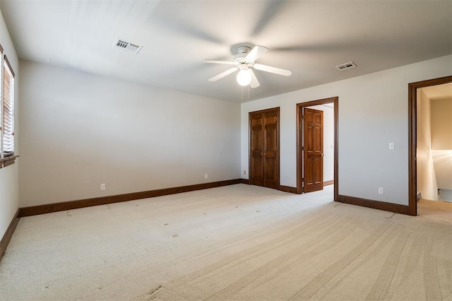 unfurnished bedroom featuring light colored carpet and ceiling fan