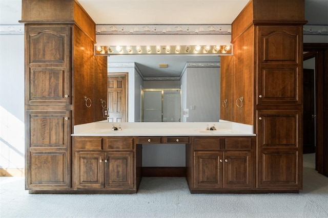 bathroom featuring vanity, an enclosed shower, and ornamental molding