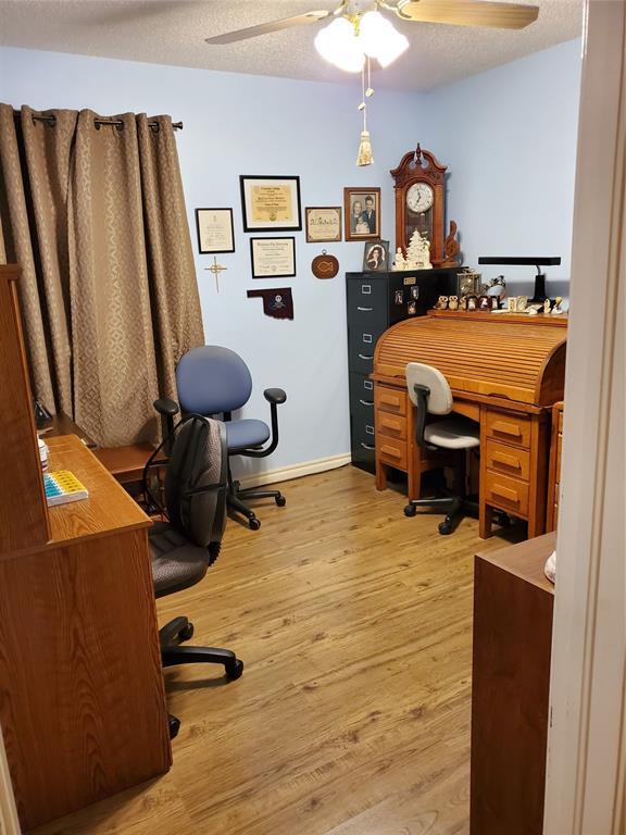 office area with ceiling fan, light hardwood / wood-style floors, and a textured ceiling