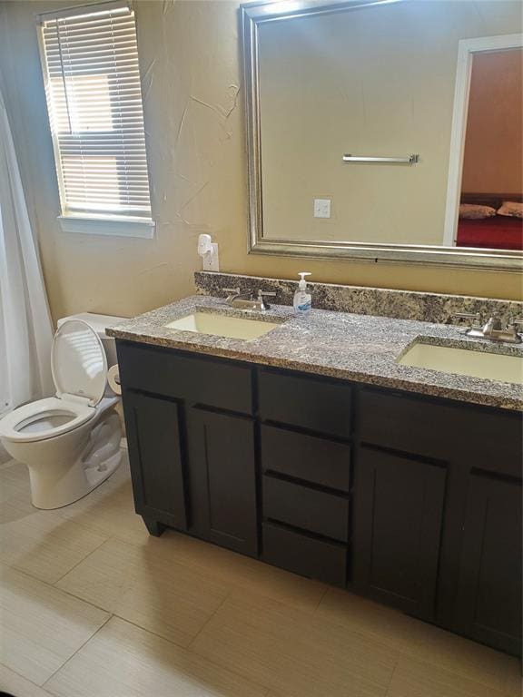 bathroom featuring tile patterned floors, vanity, and toilet