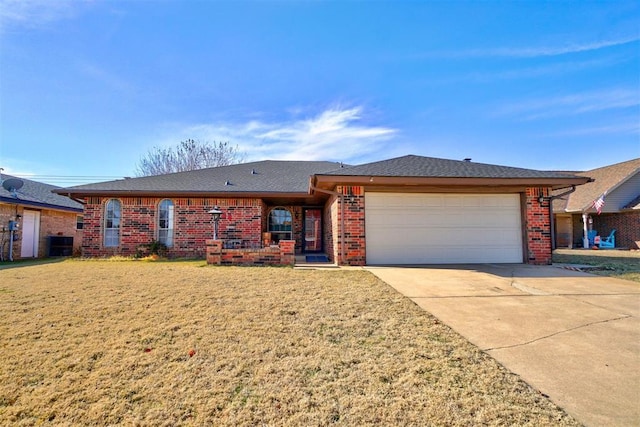 ranch-style home with central air condition unit, a front lawn, and a garage