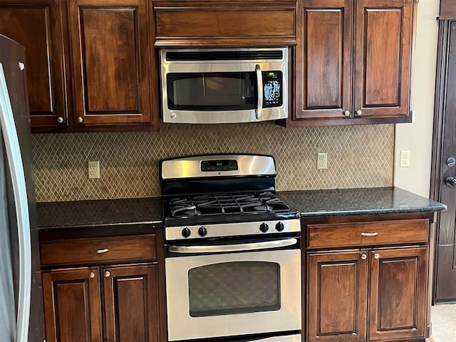 kitchen with backsplash, dark brown cabinets, and appliances with stainless steel finishes